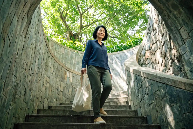 A mature man climbing a flight of outdoor steps