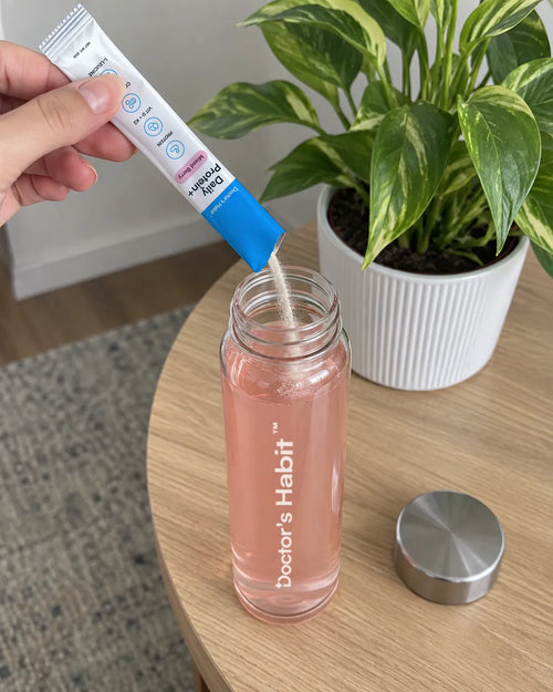 A Daily Protein+ stick pack poured into a glass